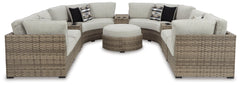 Calworth Outdoor 9-Piece Sectional with Ottoman - furniture place usa